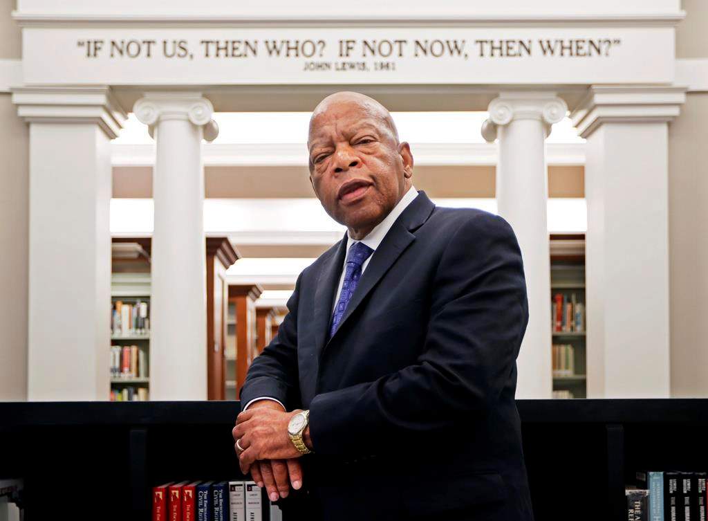 In this Nov. 18, 2016 photo U.S. Rep. John Lewis poses for a photograph under a quote of his that is displayed in the Civil Rights Room in the Nashville Public Library in Nashville, Tenn.
