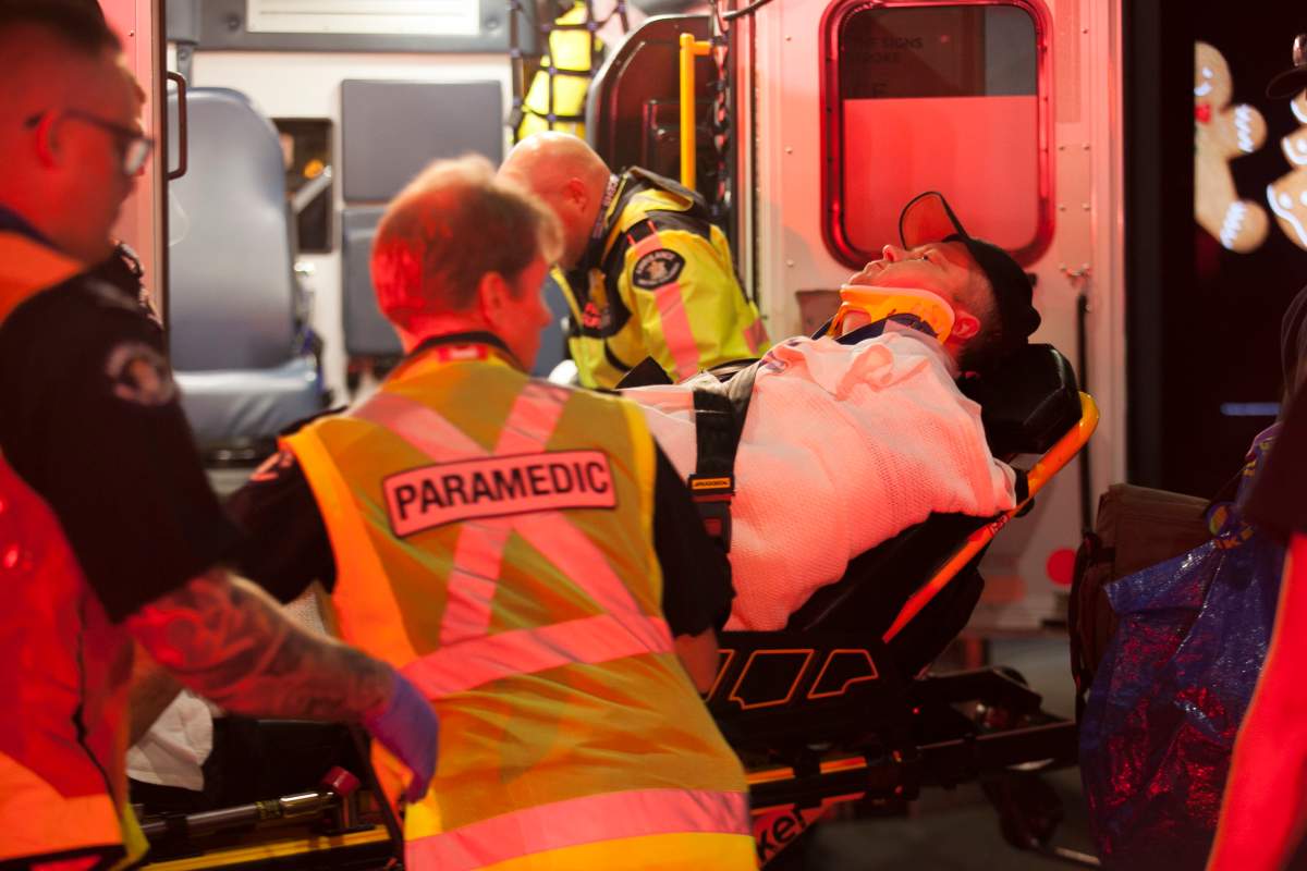 First responders attend to a man who fell down an elevator shaft in Vancouver on Monday.