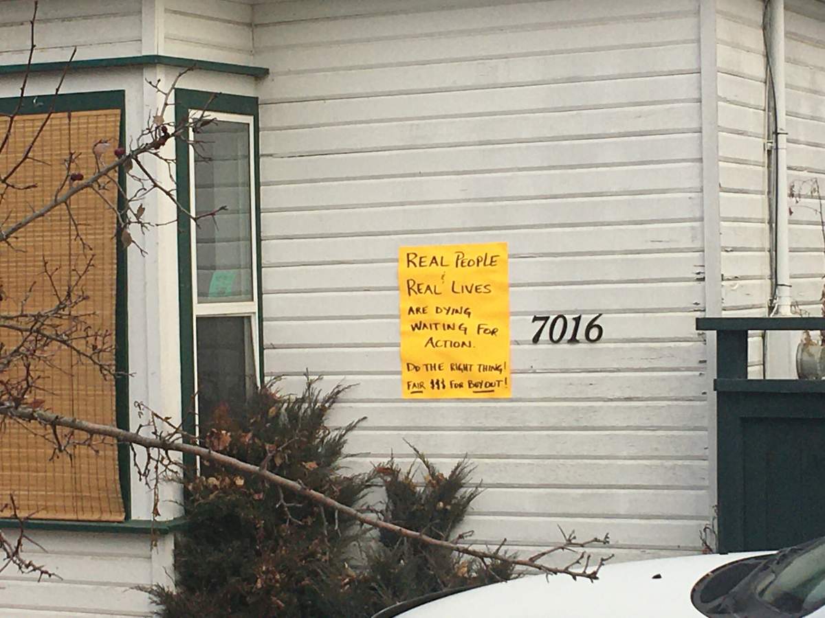 A sign on this North Ruckle home reads “real people & real lives are dying waiting for action.”
