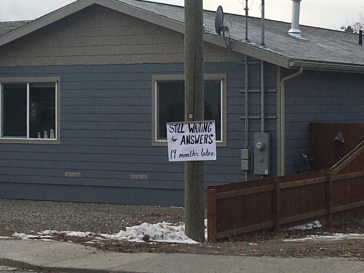 A sign in the North Ruckle neighbourhood of Grand Forks says “still waiting for answers 19 months later.”