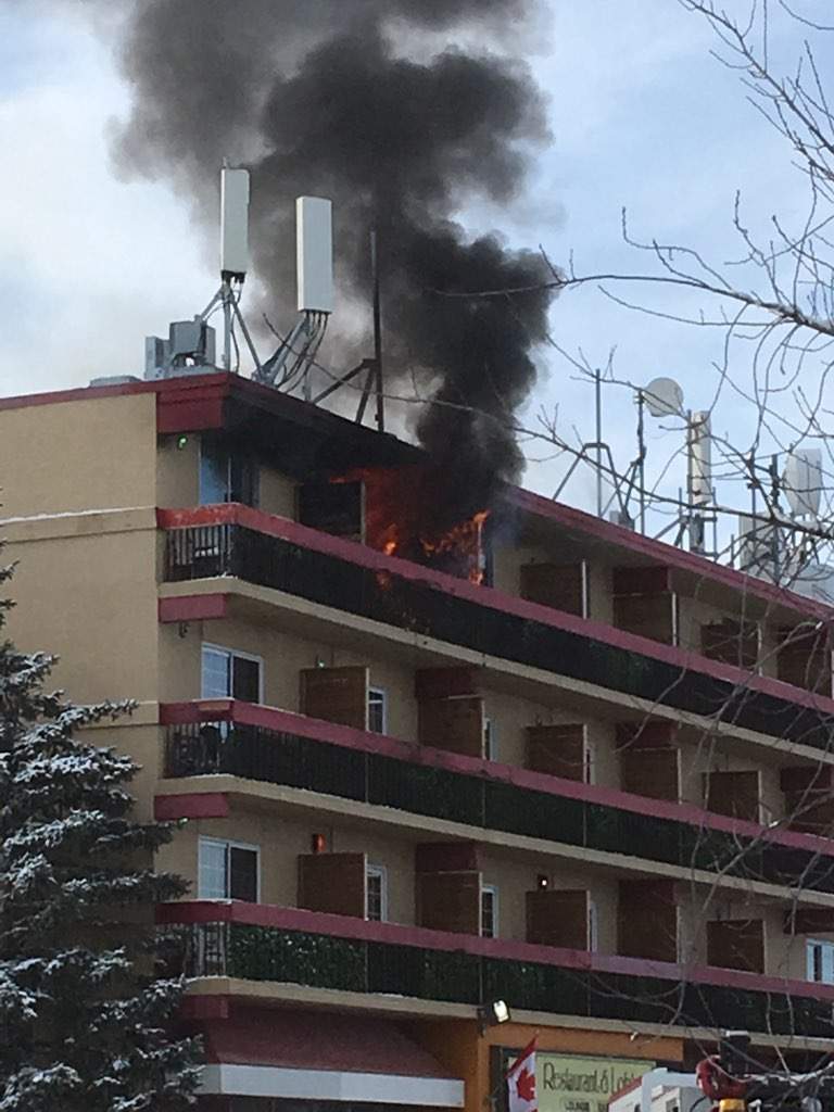 Smoke and flames emerged from a hotel in southeast Calgary on Monday, Dec. 23, 2019.