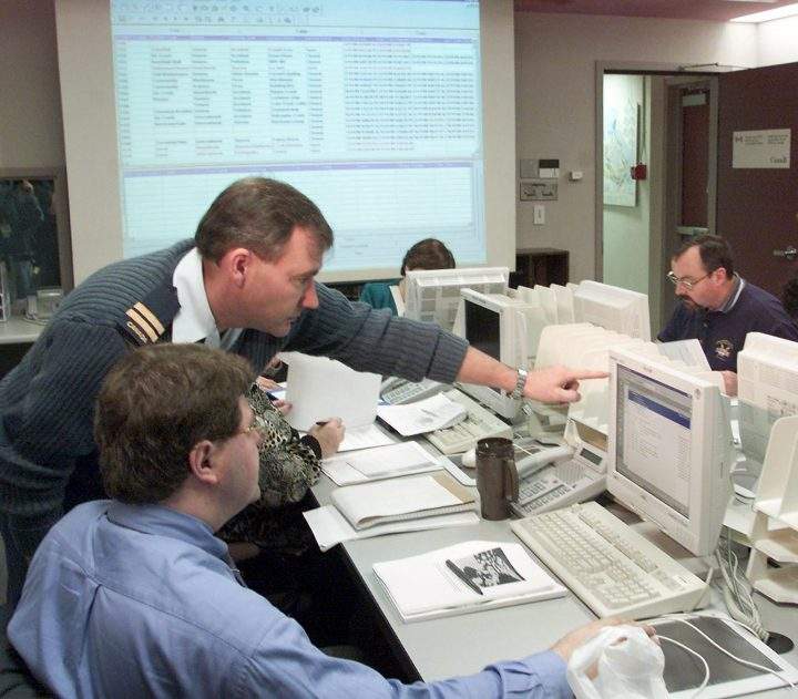 Captain Dave Wickware trains Gilles Levasseur in the report section of the Canada Year 2000 Monitoring and Coordination Centre in Ottawa, Wednesday, Nov. 24, 1999.