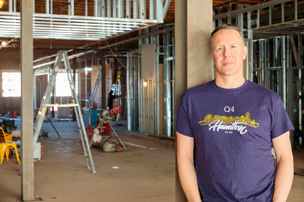 Darrell Heaps, CEO and founder of Q4 Inc., stands in the unfinished interior of the company's new office on King Street East in downtown Hamilton.