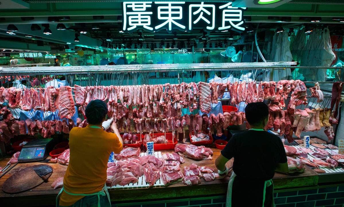 Pork is sold at a wet market under a sign reading ‘Cantonese Meat’ in Tseung Kwan O, Hong Kong, China, 27 December 2018.