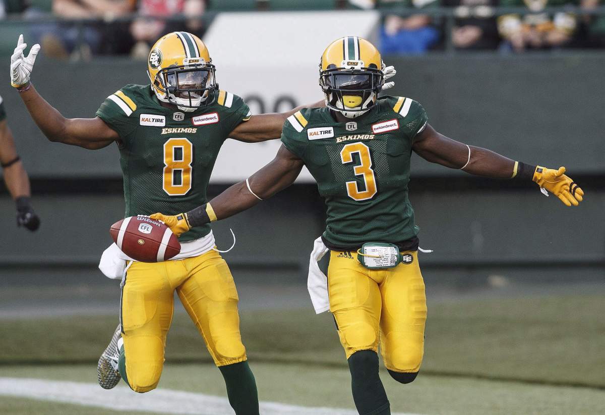 Edmonton Eskimos Kenny Stafford (8) and Natey Adjei (3) celebrate a touchdown against the B.C. Lions during first-half CFL action in Edmonton on June 29, 2018.