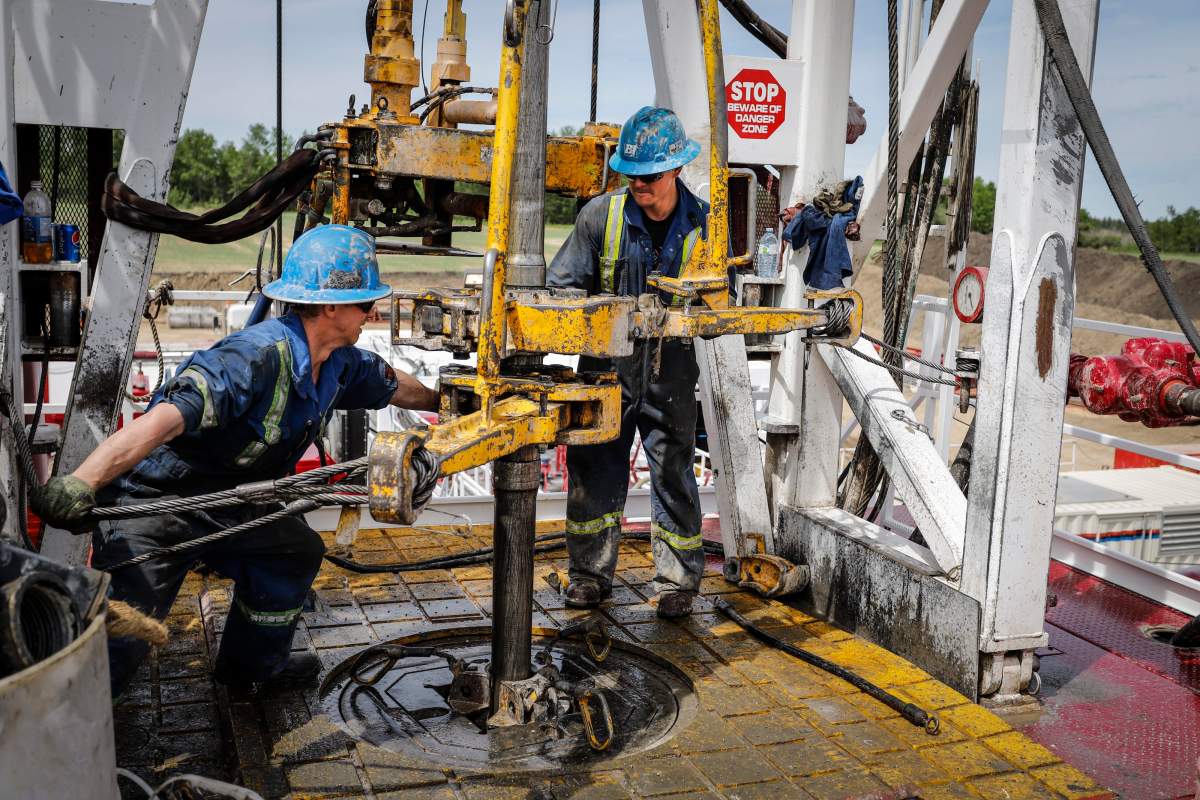 A crew on an oil rig drills for oil near Clive, Alta., Wednesday, June 5, 2019.