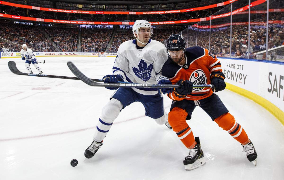 Toronto Maple Leafs’ Justin Holl (3) and Edmonton Oilers’ Sam Gagner (89) battle for the puck during second-period NHL action in Edmonton, Alta., on Saturday, Dec. 14, 2019.
