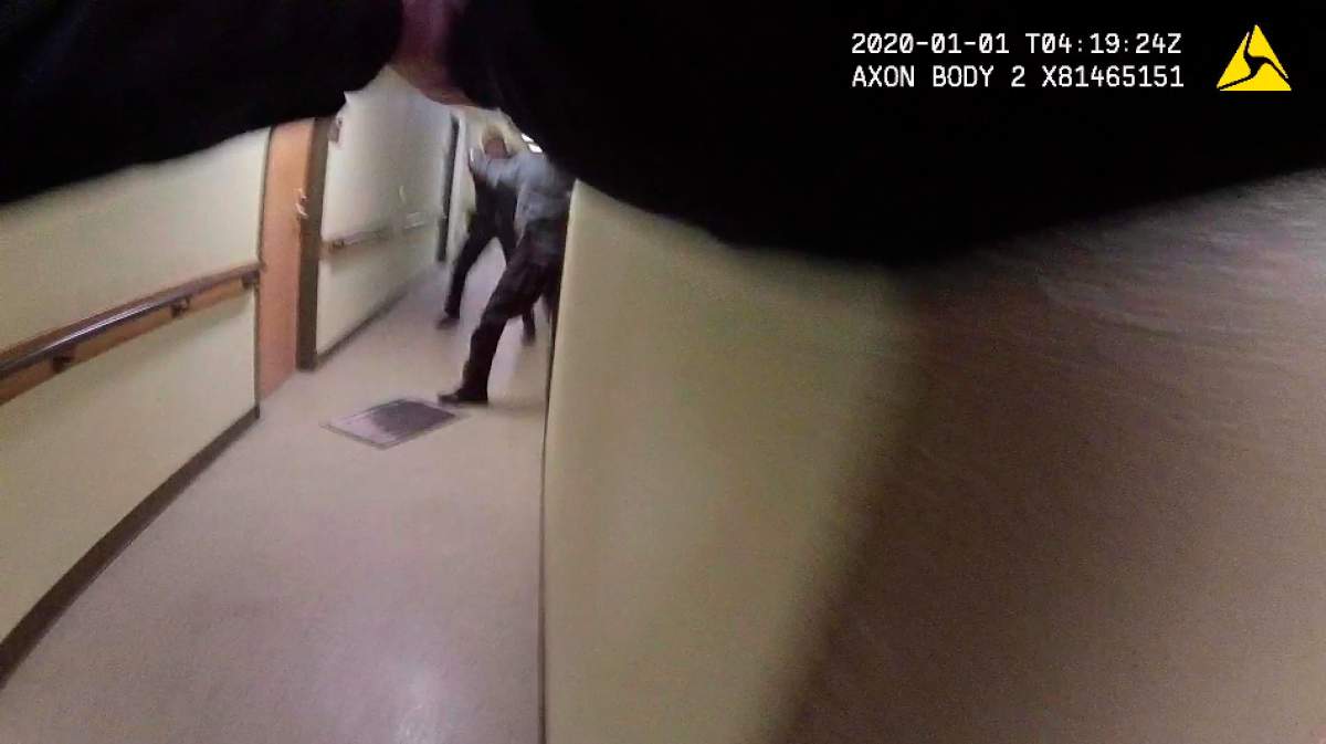 This image made from Dec. 31, 2019, video of an officer body camera provided by the Omaha Police Department shows a fatal exchange of gunfire with Terry Hudson. A man with a grey shirt seen under an officer’s arms is Hudson.