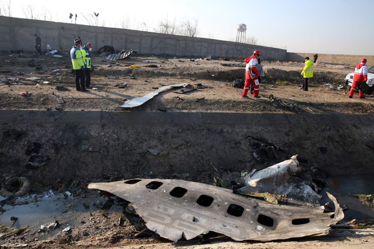 Emergency services personnel walk amidst the wreckage after an Ukraine International Airlines Boeing 737-800 carrying 176 people crashed near Imam Khomeini Airport in Tehran, killing everyone on board; in Shahriar, Iran, 08 January 2020.