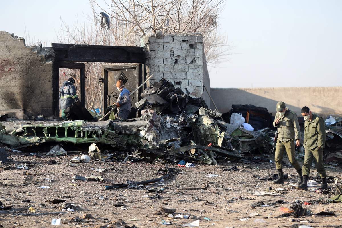 Iranian soldiers stand guard next to the wreckage after an Ukraine International Airlines Boeing 737-800 carrying 176 people crashed near Imam Khomeini Airport in Tehran, killing everyone on board; in Shahriar, Iran, 08 January 2020.