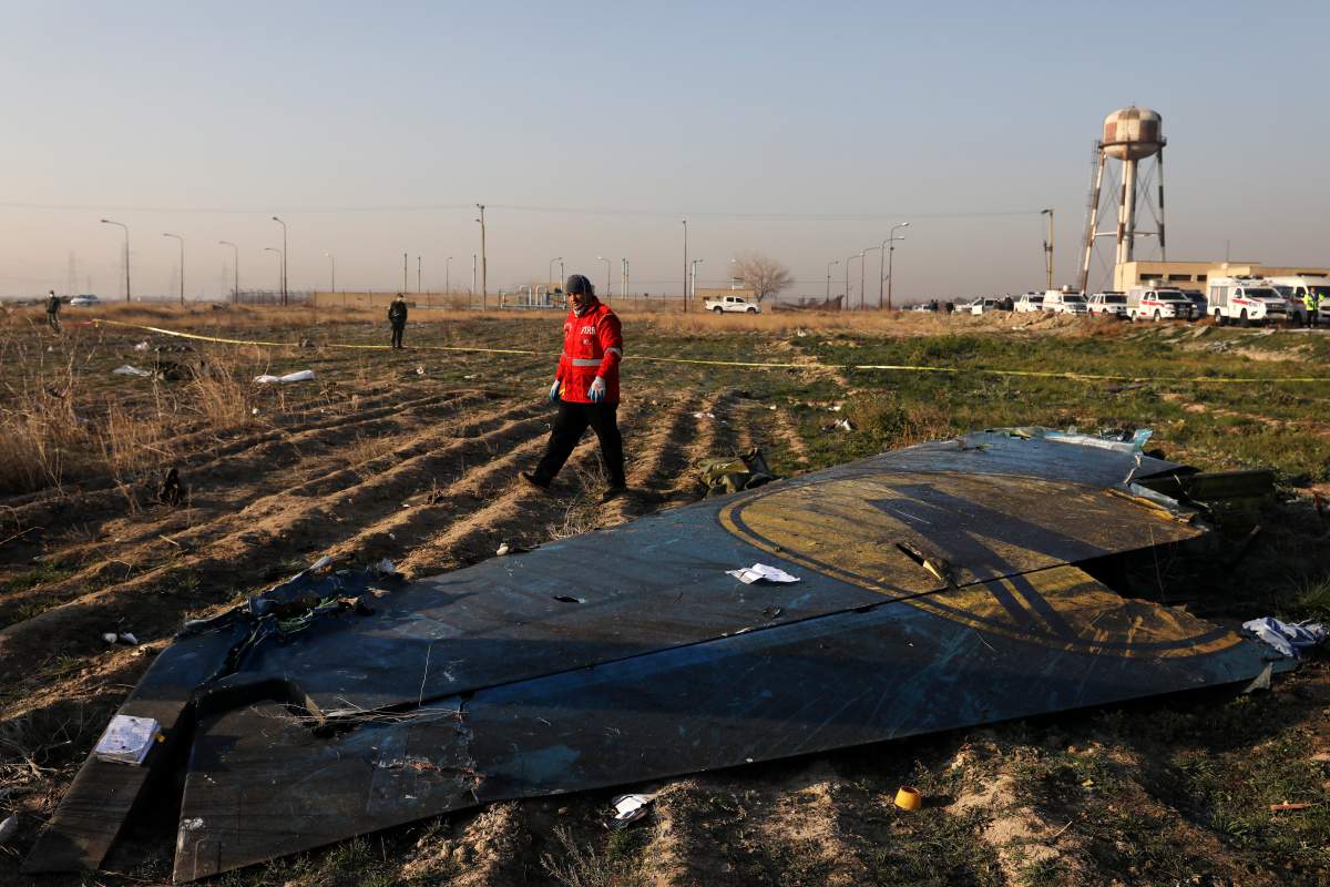 A rescue worker searches the scene where a Ukrainian plane crashed in Shahedshahr southwest of the capital Tehran, Iran, Wednesday, Jan. 8, 2020. A Ukrainian airplane carrying 176 people crashed on Wednesday shortly after takeoff from Tehran’s main airport, killing all onboard.