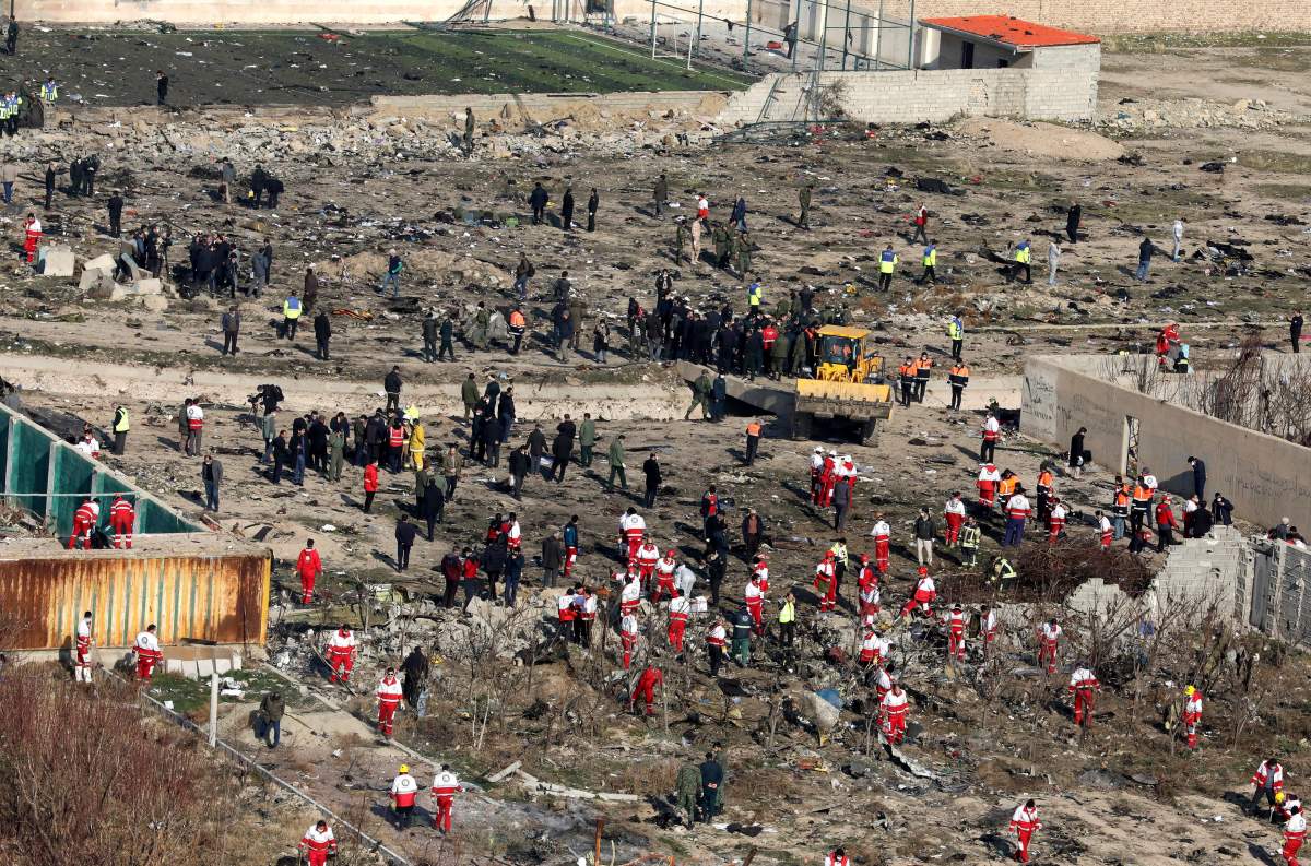 Rescue workers search the scene where an Ukrainian plane crashed in Shahedshahr, southwest of the capital Tehran, Iran, Wednesday, Jan. 8, 2020. A Ukrainian passenger jet carrying 176 people crashed on Wednesday, just minutes after taking off from the Iranian capital’s main airport, turning farmland on the outskirts of Tehran into fields of flaming debris and killing all on board.