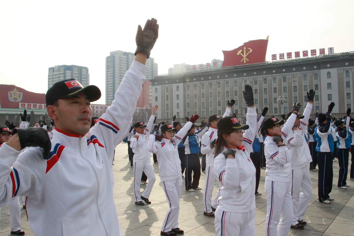 A group of government officials participate in a group exercises on the first official “sports day” of the new year at the Kim Il Sung Square in Pyongyang, North Korea, on Sunday, January 12, 2020.