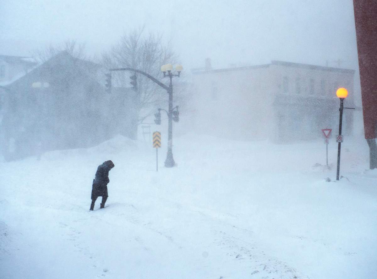 A woman makes her way through the snow-covered streets in St. John’s on Friday, January 17, 2020. The City of St. John’s has declared a state of emergency, ordering businesses closed and vehicles off the roads as blizzard conditions descend on the Newfoundland and Labrador capital. THE CANADIAN PRESS/Andrew Vaughan