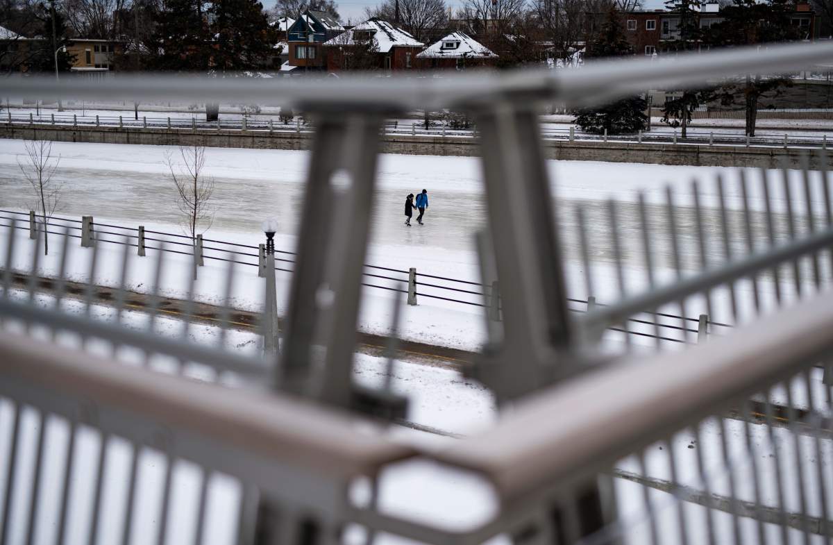 Skaters are seen from the Flora Footbridge as they skate along the Rideau Canal Skateway in Ottawa on the opening day of its 50th season, on Saturday, Jan. 18, 2020.