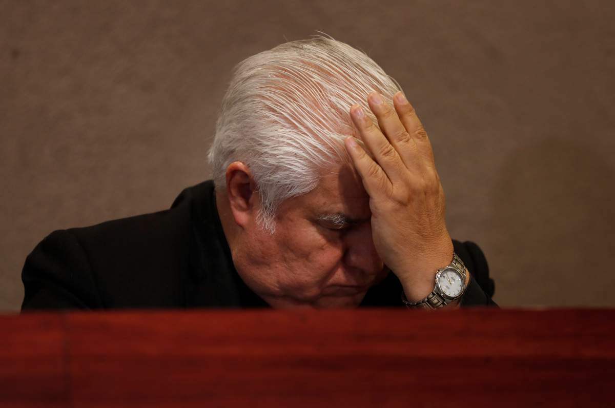 In this Jan. 14, 2020 photo, Rogelio Cabrera, president of the Mexican bishops conference, takes his hand to his forehead after speaking during a news conference in Mexico City.