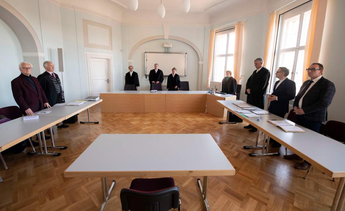 Volker Buchloh, Presiding Judge at Higher Regional Court, centre, opens a trial at the Higher Regional Court in Naumburg, Germany, Jan. 21, 2020.