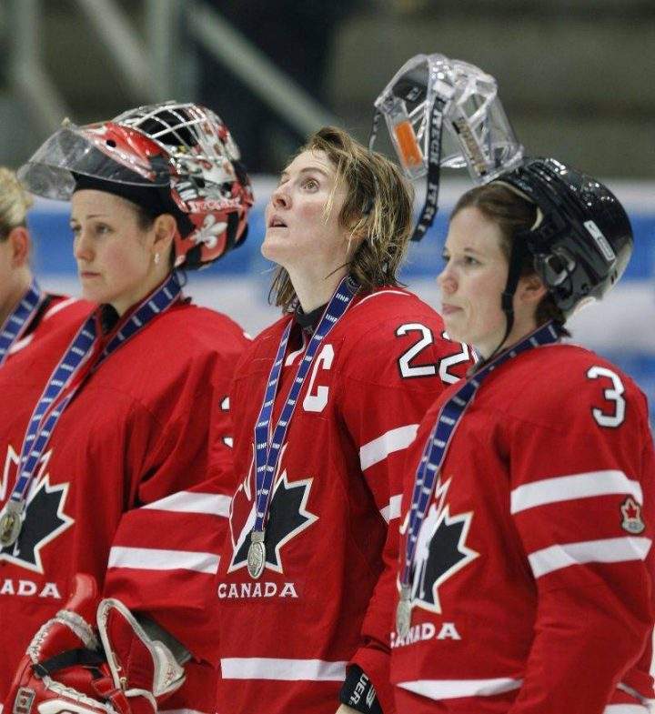 Team Canada captain Hayley Wickenheiser, flanked by goalkeeper Charline Labonte, left, and Carla MacLeod looks up at the scoreboard during medal presentation after losing the gold medal to team USA at the World Women Hockey Championship Sunday, April 12, 2009, in Hameenlinna, Finland.
