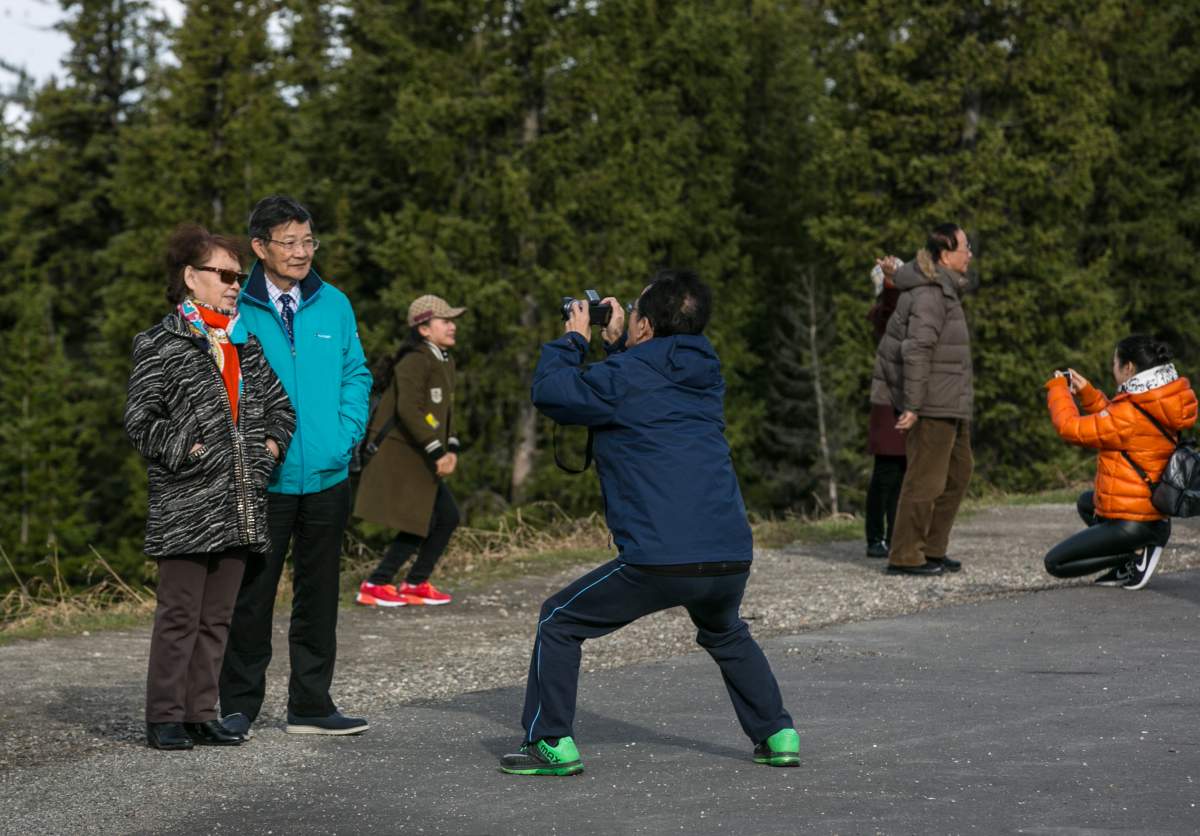 A group of tourists stop to take pictures of the Rockies along the Icefields Parkway between Lake Louise and Jasper on April 25, 2016 near Jasper, Alberta, Canada.