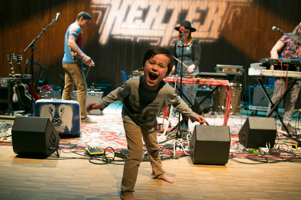 A kid takes the stage at Studio Bell between performances at the 2019 Block Heater music festival.