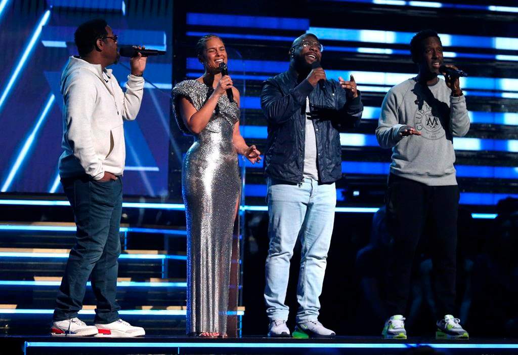 Nathan Morris, from left, Wanya Morris, Shawn Stockman of Boyz II Men and Alicia Keys sing a tribute in honour of the late Kobe Bryant at the 62nd annual Grammy Awards on Sunday in Los Angeles, Calif.