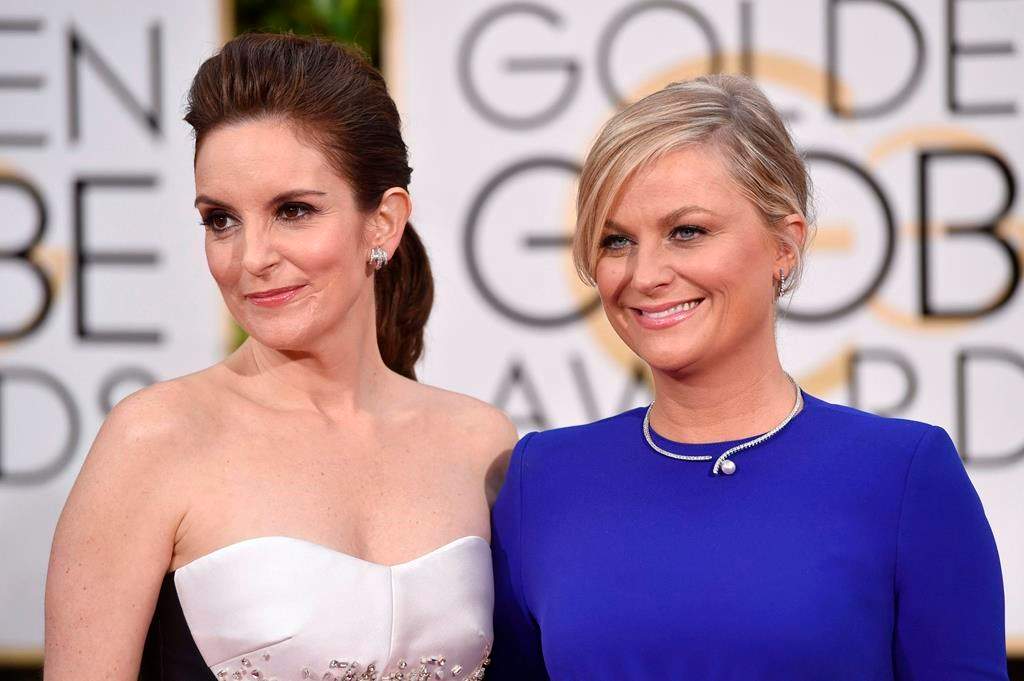 In this Jan. 11, 2015 file photo, Tina Fey, left, and Amy Poehler arrive for the 72nd annual Golden Globe Awards in Beverly Hills, Calif.