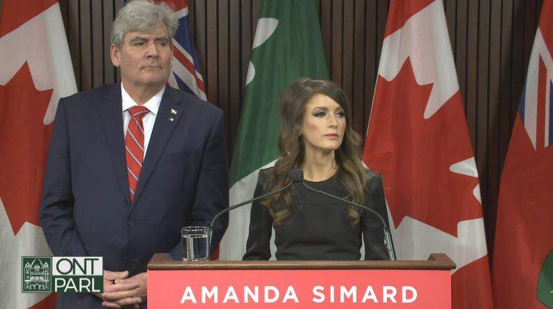 Amanda Simard and John Fraser speak at Queen's Park on Thursday.