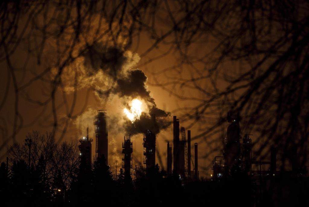 A flare stack lights the sky along refinery row in Edmonton, Alta., on Friday, Dec. 28, 2018.
