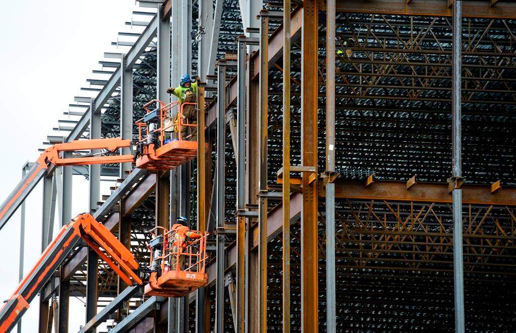 Steel workers build a structure in Ottawa on March 5, 2018. Canada saw its first monthly jobs gain since September last month, according to new labour data. THE CANADIAN PRESS/Sean Kilpatrick.