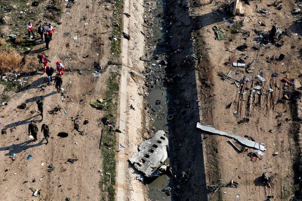 In this Wednesday, Jan. 8, 2020 photo, rescue workers search the scene where a Ukrainian plane crashed in Shahedshahr, southwest of the capital Tehran, Iran. THE CANADIAN PRESS/AP-Ebrahim Noroozi.
