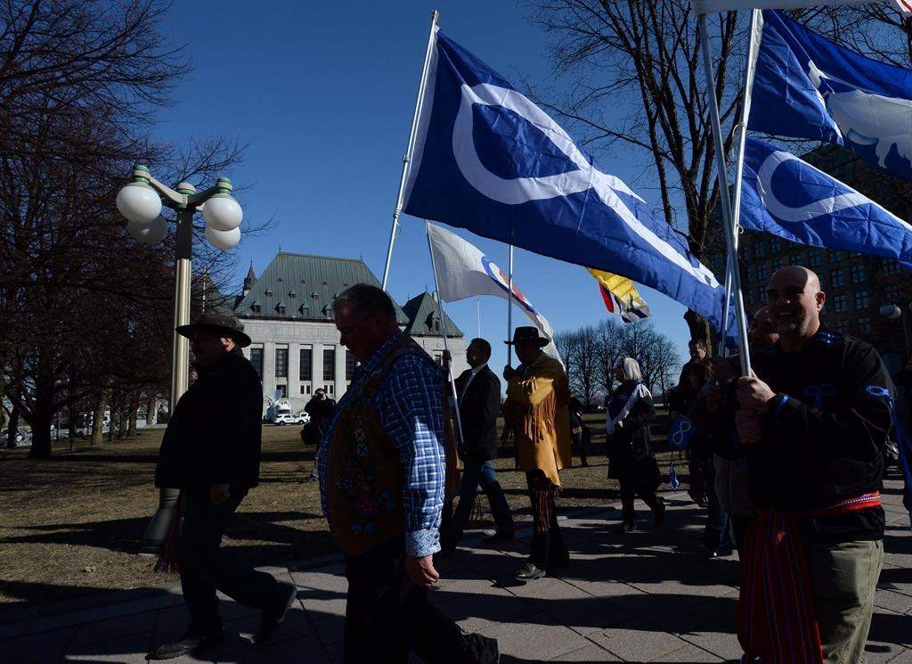 The regional Metis presidents of Ontario, Alberta and Saskatchewan are calling for reform of the Metis National Council, raising serious concerns about "dysfunction" and about a lack of transparency involving financial and administrative matters within the national body. David Chartrand, president of the Manitoba Metis Federation, middle, carries the Metis flag as he and fellow Metis Federation leaders and delagates march to the Supreme Court of Canada in Ottawa, Thursday, April 14, 2016. THE CANADIAN PRESS/Sean Kilpatrick.