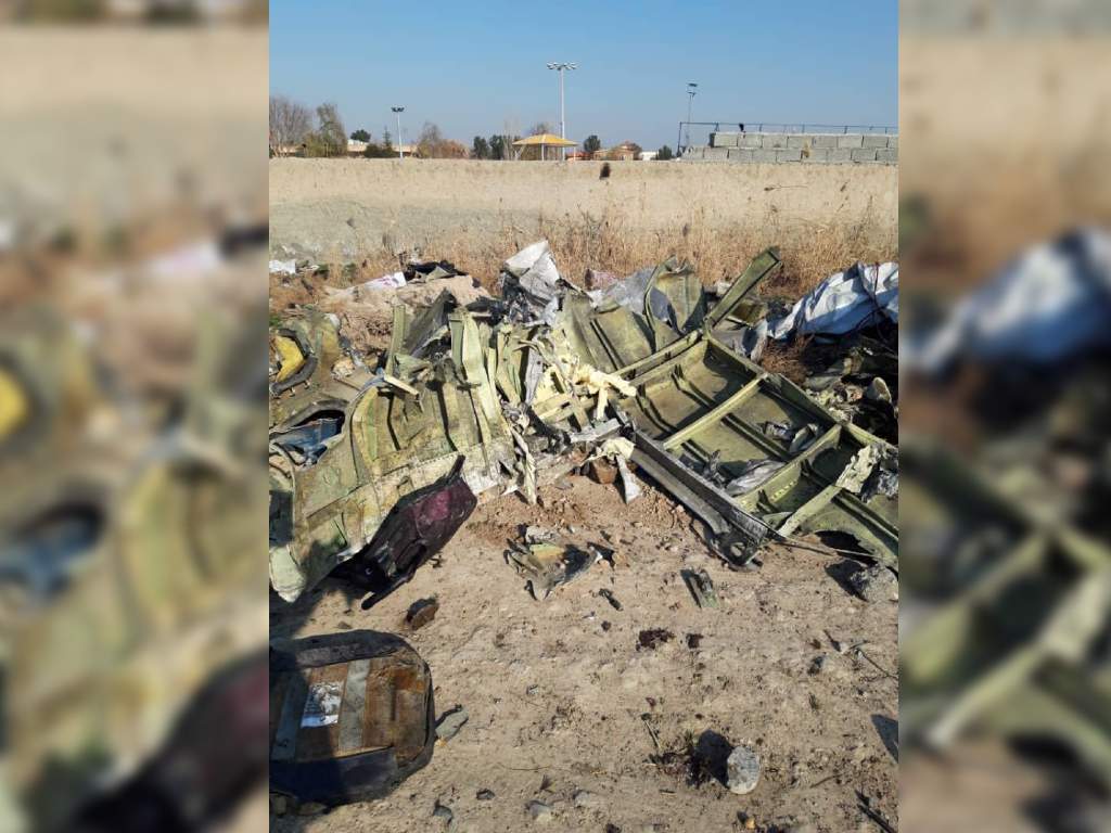 Charred pieces of the are pictured laying on the ground near the crash site.
