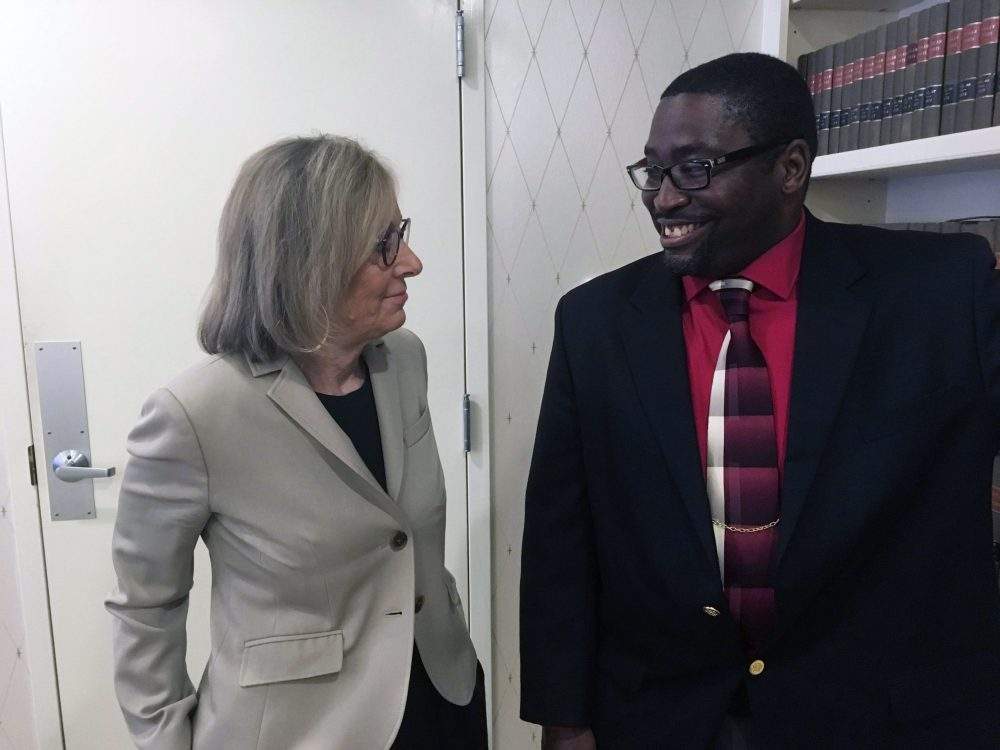 Sauntore Thomas, right, and his lawyer, Deborah Gordon, left, talk, Thursday, Jan. 23, 2020 in Bloomfield Hills, Mich.