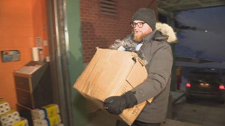 Connor Curran of Local Laundry drops donations off at the Calgary Drop-In Centre.