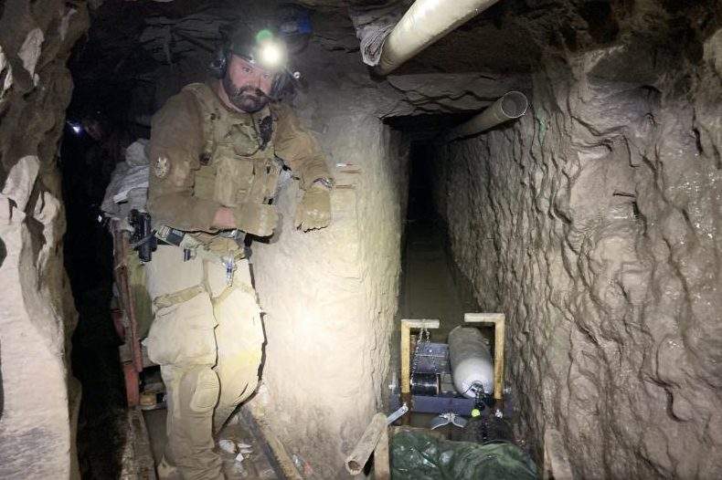 A Customs and Border Protection officer is shown inside a smuggling tunnel under the U.S.-Mexico border.