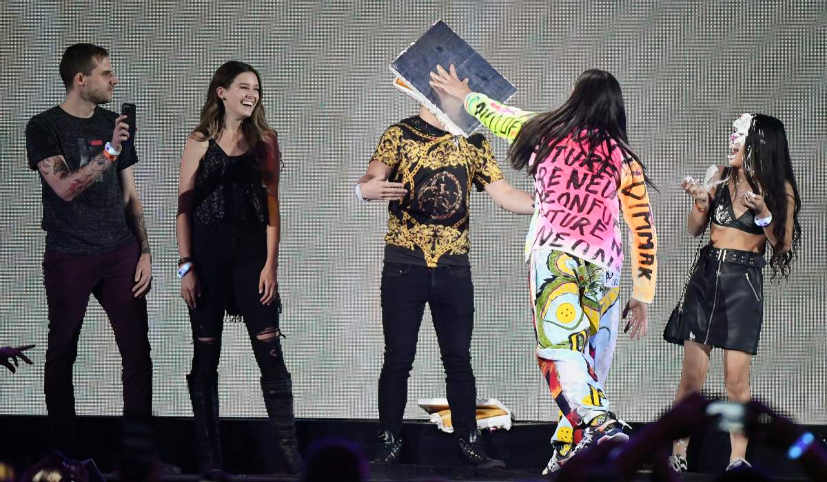 DJ/producer Steve Aoki (2nd R) throws a cake at a fan as he performs during the 2019 iHeartRadio Music Festival at T-Mobile Arena on Sept. 20, 2019, in Las Vegas, Nev. (Photo by Ethan Miller/Getty Images)