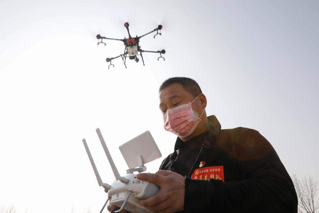 A local resident using a drone sprays disinfectant at a village in Pingdingshan, in China’s central Henan province, on Jan. 31, 2020, during the virus outbreak in Hubei’s city of Wuhan.