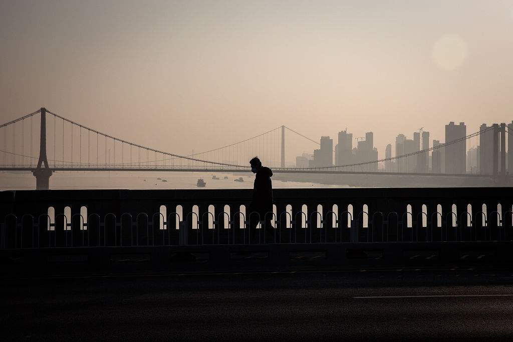 A resident wears a protective mask as he walks across the Yangtze River Bridge on Jan. 31, 2020 in Wuhan, China.