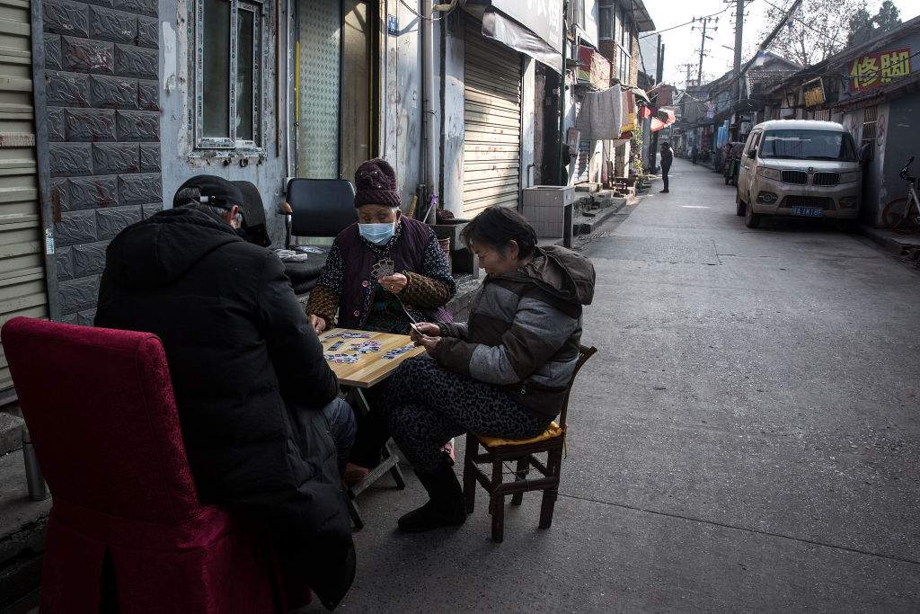 Three residents play cards in an alley on Jan. 31, 2020 in Wuhan, China.