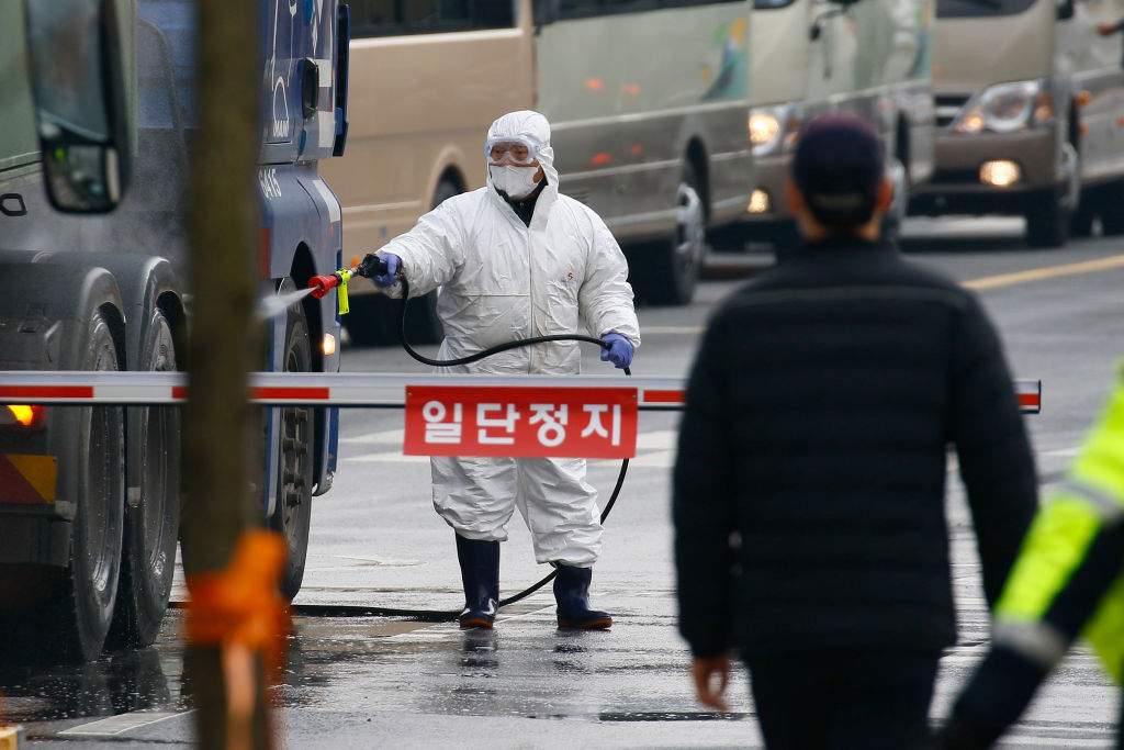 An official disinfects a road near a state facility in Jincheon, some 90 kilometres southeast of Seoul, on Jan. 31, 2020, before the arrival of South Korean evacuees from Wuhan, China.