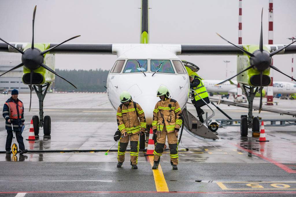 Firefighters of the Riga airport spray antiseptic agents around aircraft to prevent the spreading of a new coronavirus. Riga, Latvia, on Jan. 31, 2020.