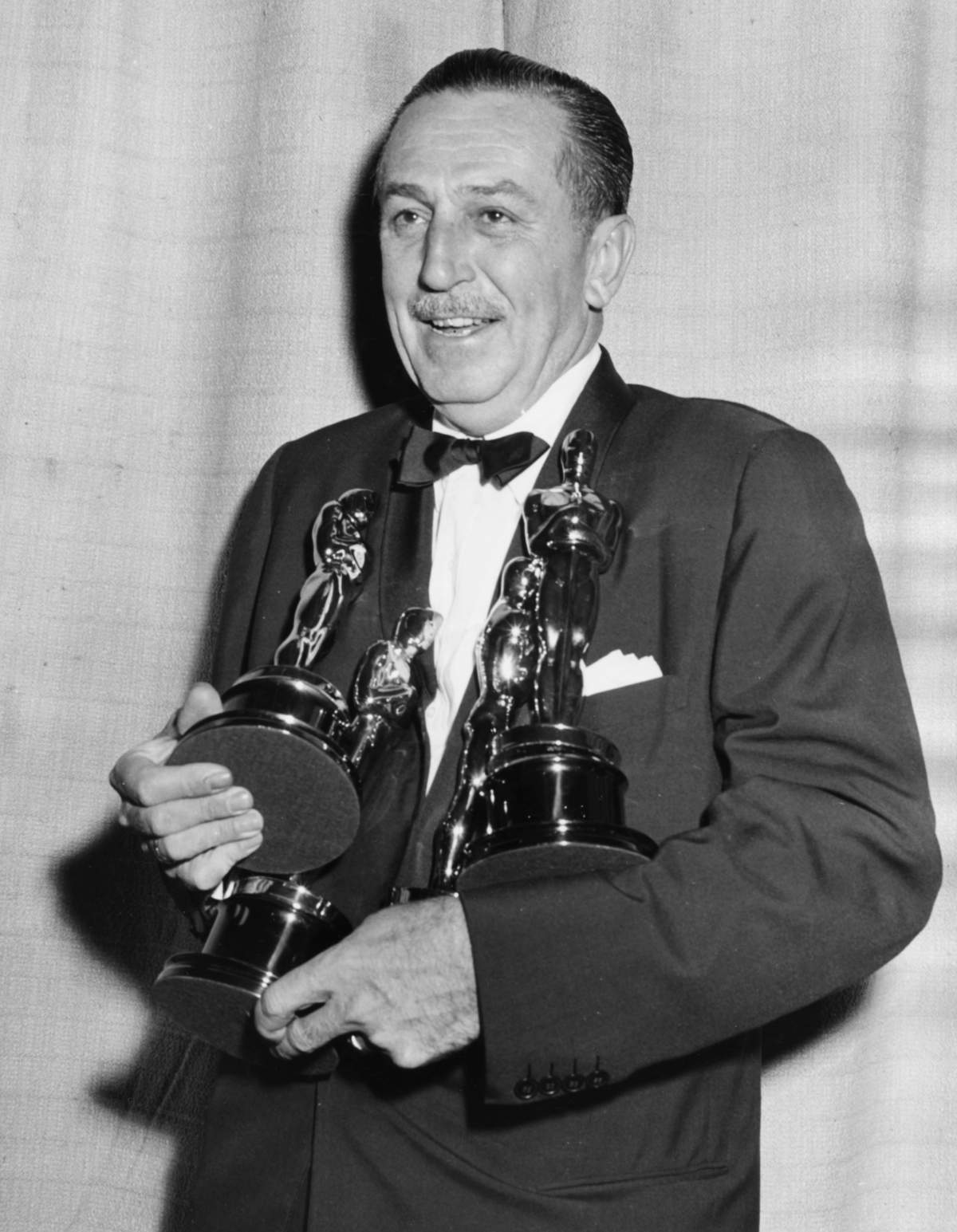 Filmmaker Walt Disney holding his four Oscars for four different films at the 26th Academy Awards, March 25, 1954. (Photo by Archive Photos/Getty Images)