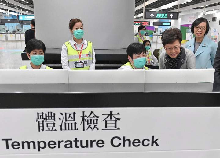 Officials review a health surveillance station at Hong Kong Airport, in this government handout photo.