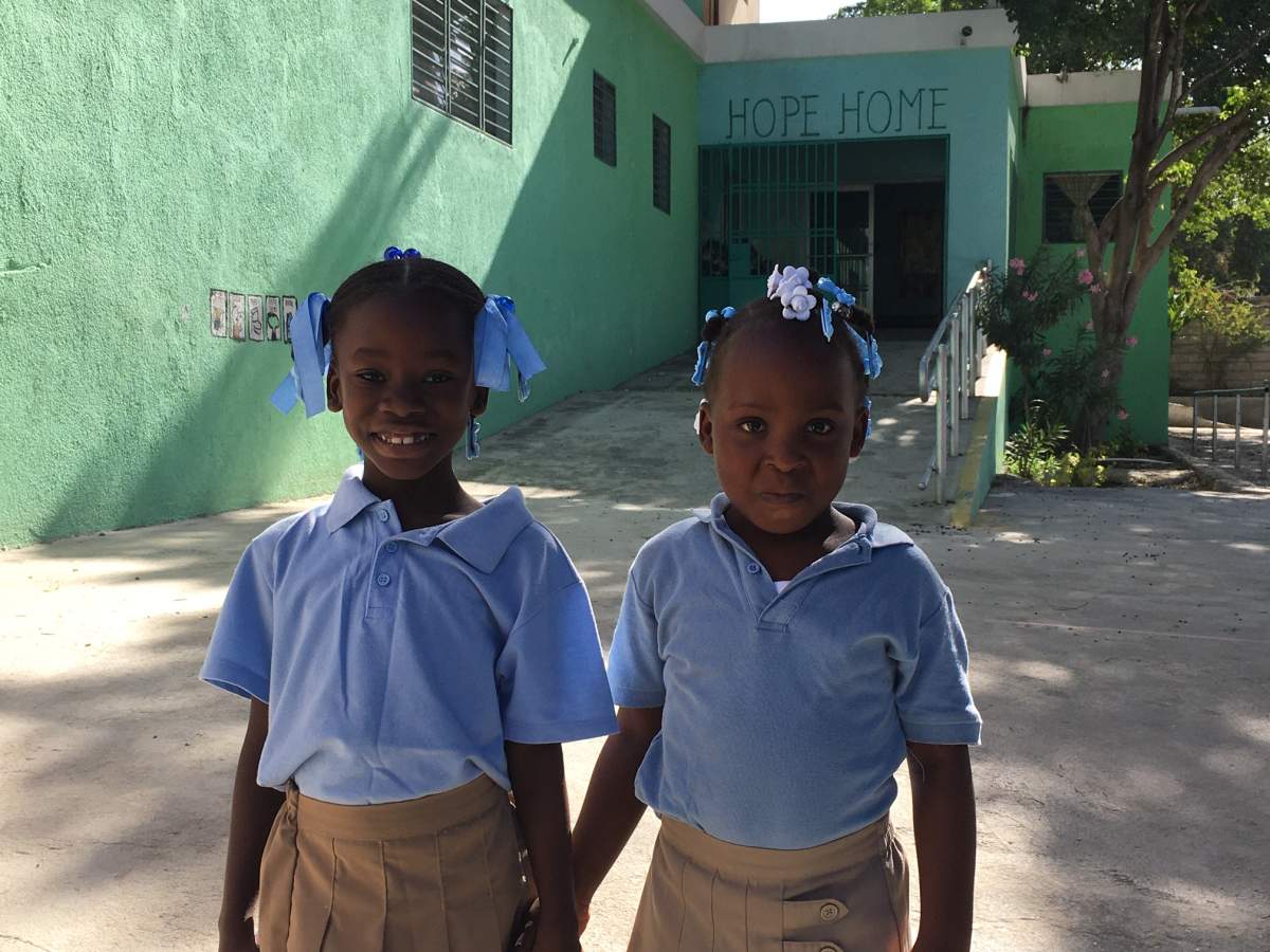Two girls hold hands at Hope Home near Port-au-Prince on Jan. 10, 2020.