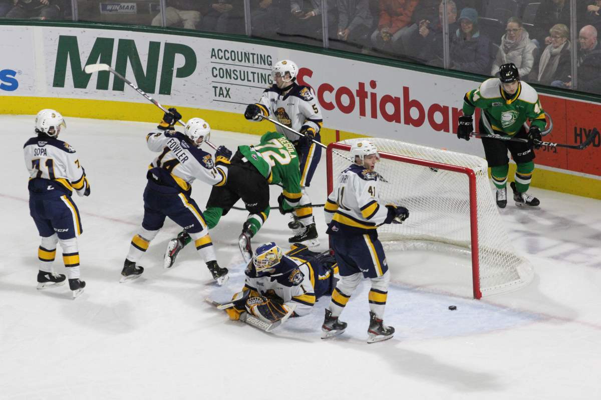 London Knights defenceman Alec Regula gets knocked to the ice after scoring what would end up as the game-winning goal in a 6-2 London victory over the Erie Otters on Jan. 19, 2020.