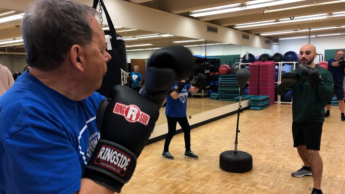 John Dawes (left) receives boxing instruction from Rock Steady coach Patrick Bernat.