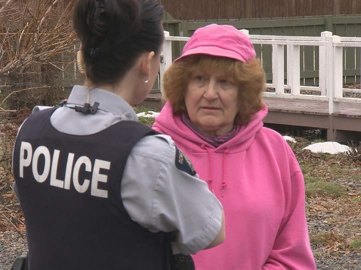Geraldine Mailloux talks to a Kelowna RCMP officer on Thursday.