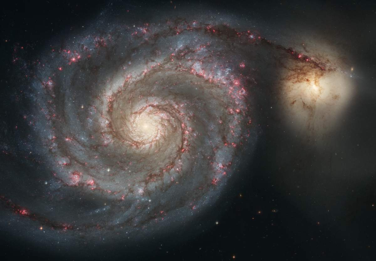 The graceful, winding arms of the majestic spiral galaxy M51 (NGC 5194) appear like a grand spiral staircase sweeping through space.