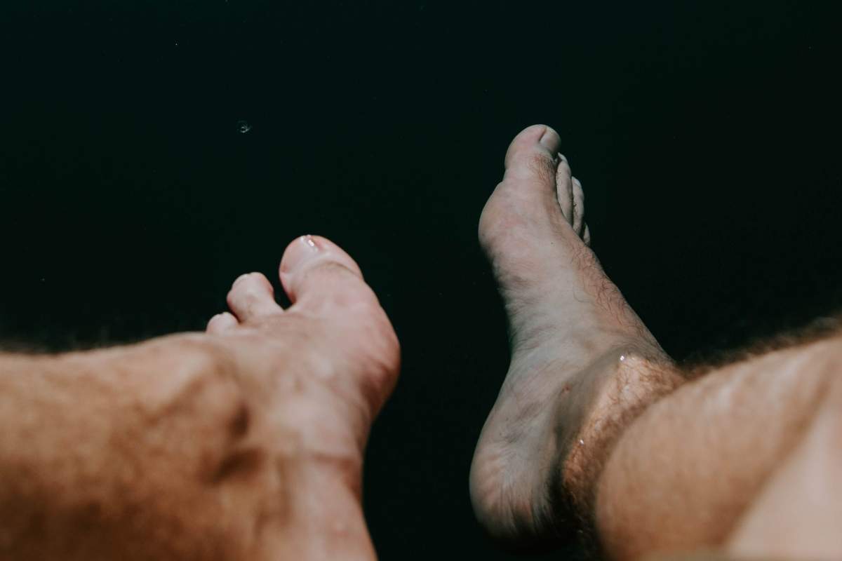 A Florida man woke to find a home intruder inspecting his feet, according to police.