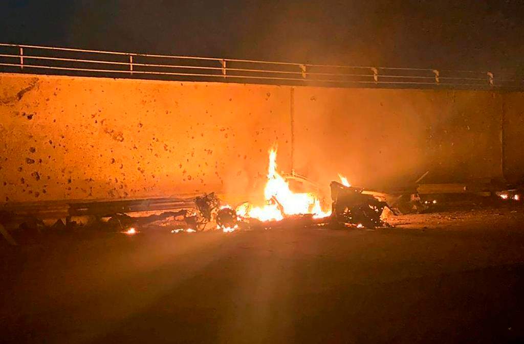 This photo released by the Iraqi Prime Minister Press Office shows a burning vehicle at the Baghdad International Airport following an airstrike in Baghdad, Iraq early Friday, Jan. 3, 2020.